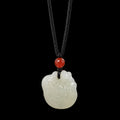 Nephrite jade zodiac rooster pendant on dark studio background
