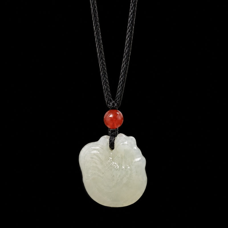 Nephrite jade zodiac rooster pendant on dark studio background