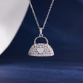 S925 silver heart handbag necklace on deep blue background