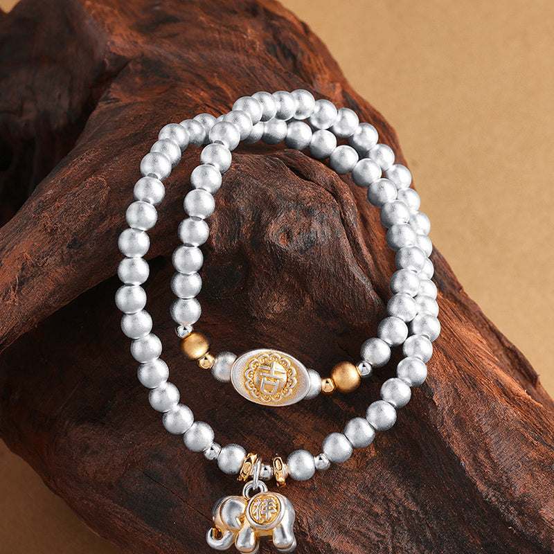 999 fine silver elephant double-wrap bracelet on driftwood