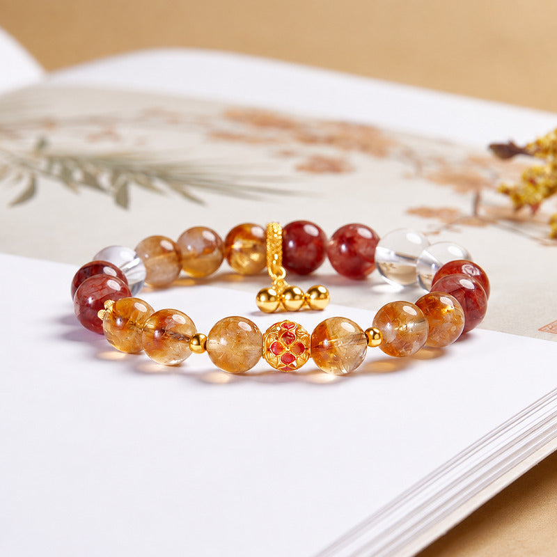 Enamel flower crystal bracelet on a softly lit book background