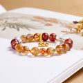 Enamel flower crystal bracelet on a softly lit book background