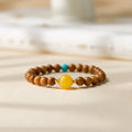 Cook wood bracelet with amber glass center bead