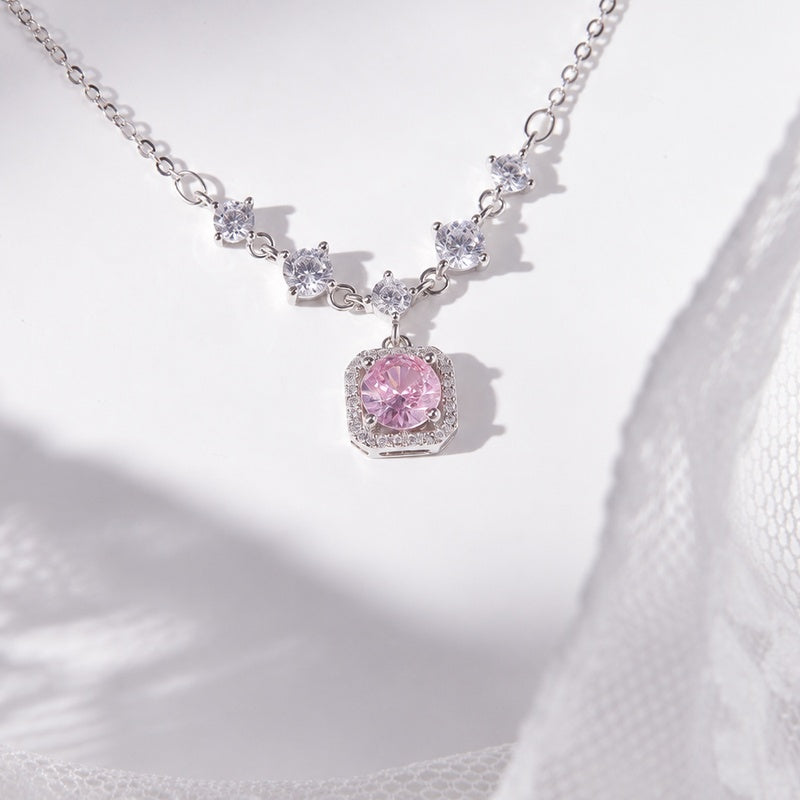 Pink cubic zirconia silver halo necklace centered on pale ceramic and lace