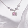 Pink cubic zirconia silver halo necklace centered on pale ceramic and lace