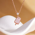 Pink mother-of-pearl popsicle necklace on warm sculptural display