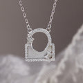 Silver star lock necklace suspended against taupe and lace