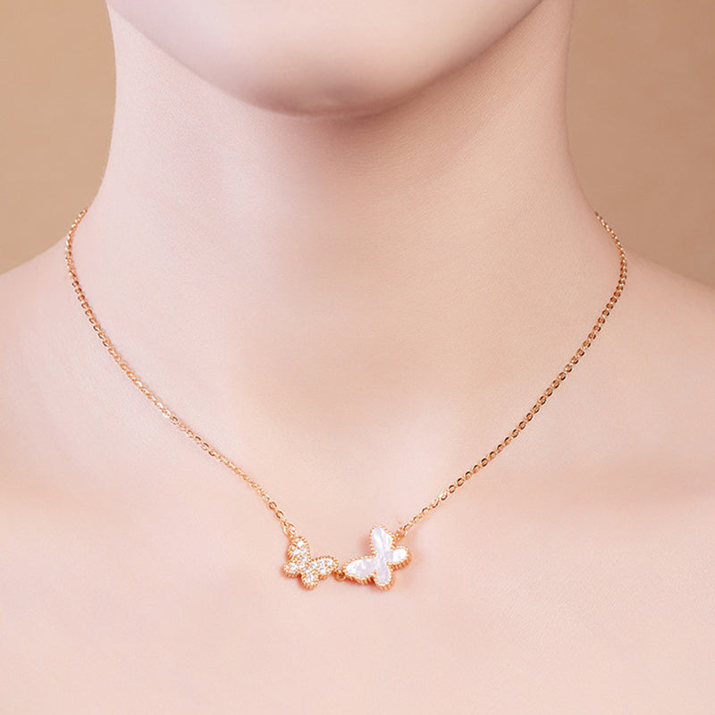 Model wearing delicate double butterfly mother-of-pearl necklace