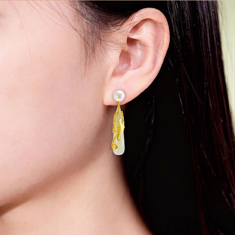 Model wearing one Hetian jade phoenix earring