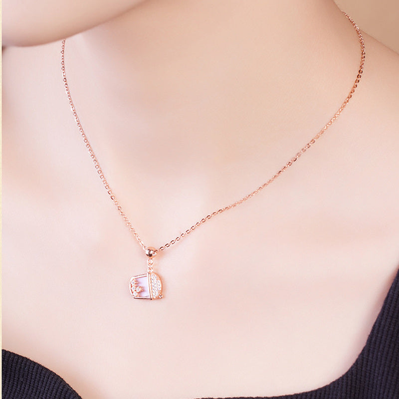 Model wearing a rose-gold-tone milk tea cup pendant necklace