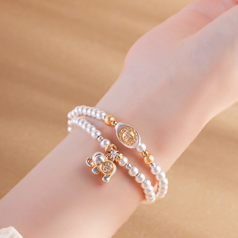 Model wearing 999 fine silver elephant double-wrap bracelet