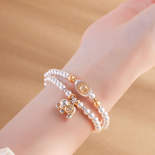 Model wearing 999 fine silver elephant double-wrap bracelet