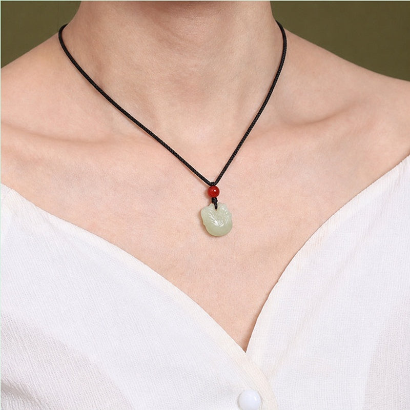 Model wearing nephrite jade rooster pendant on black cord