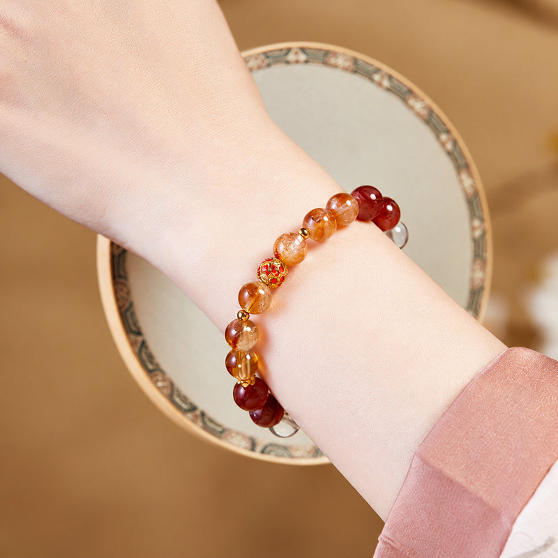 Yellow tower crystal enamel bracelet worn with a pink sleeve