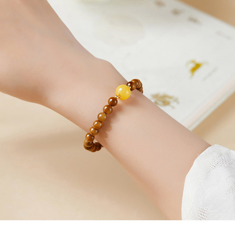 Supplier model wearing cook wood beaded bracelet