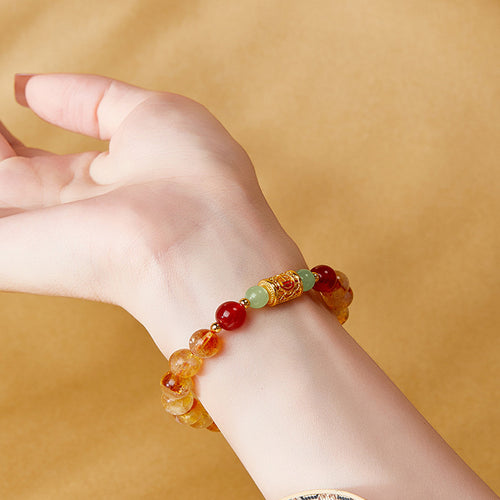 Model wearing yellow tower crystal red agate jade bracelet