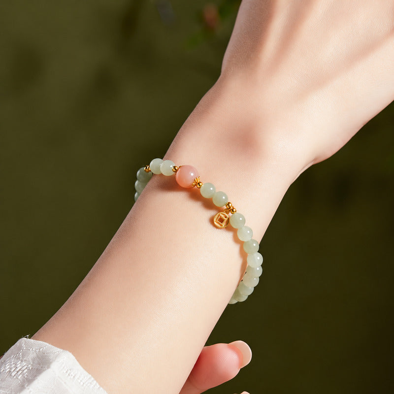 Nephrite jade and orange moonstone bracelet worn on wrist