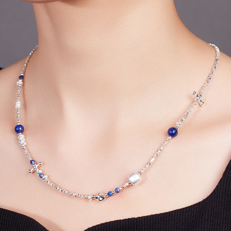 Model wearing lapis lazuli freshwater pearl necklace angled view