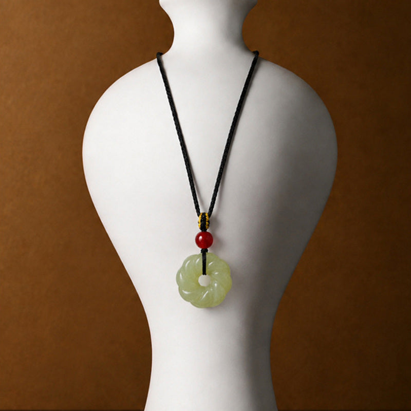 Nephrite jade twist ring pendant necklace displayed on a white bust