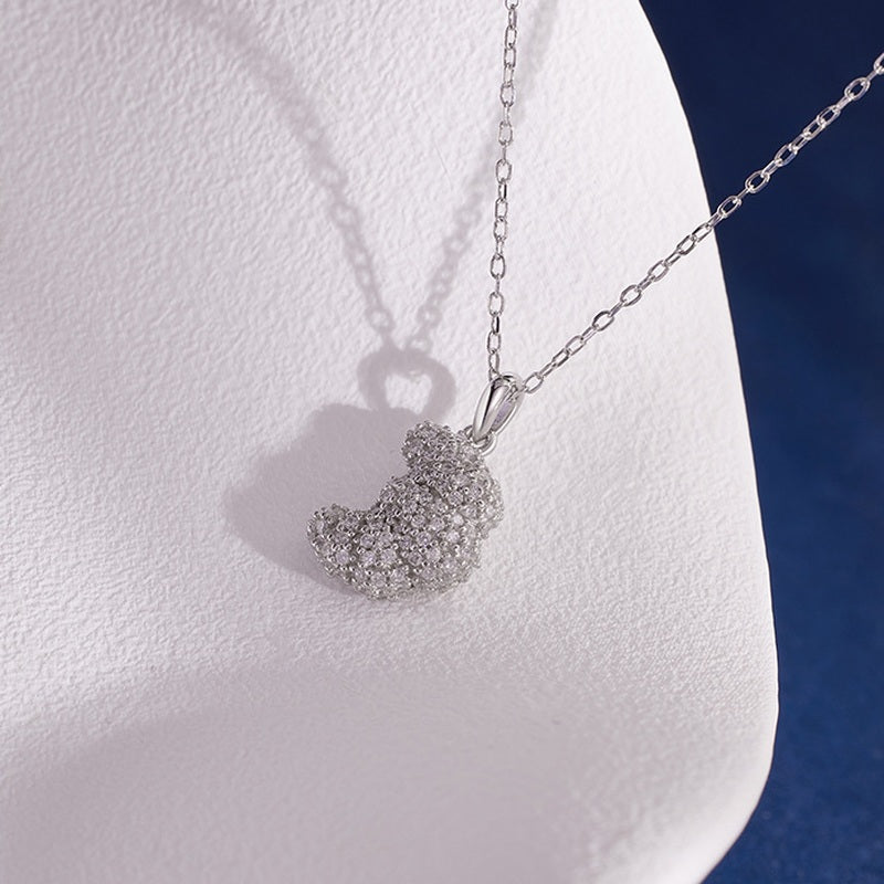 Polished croissant pendant necklace with soft sculptural shadow