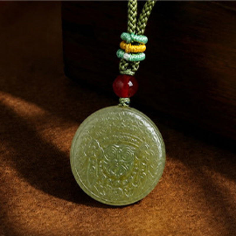 Close view of carved Zakiram nephrite jade pendant on full wood background