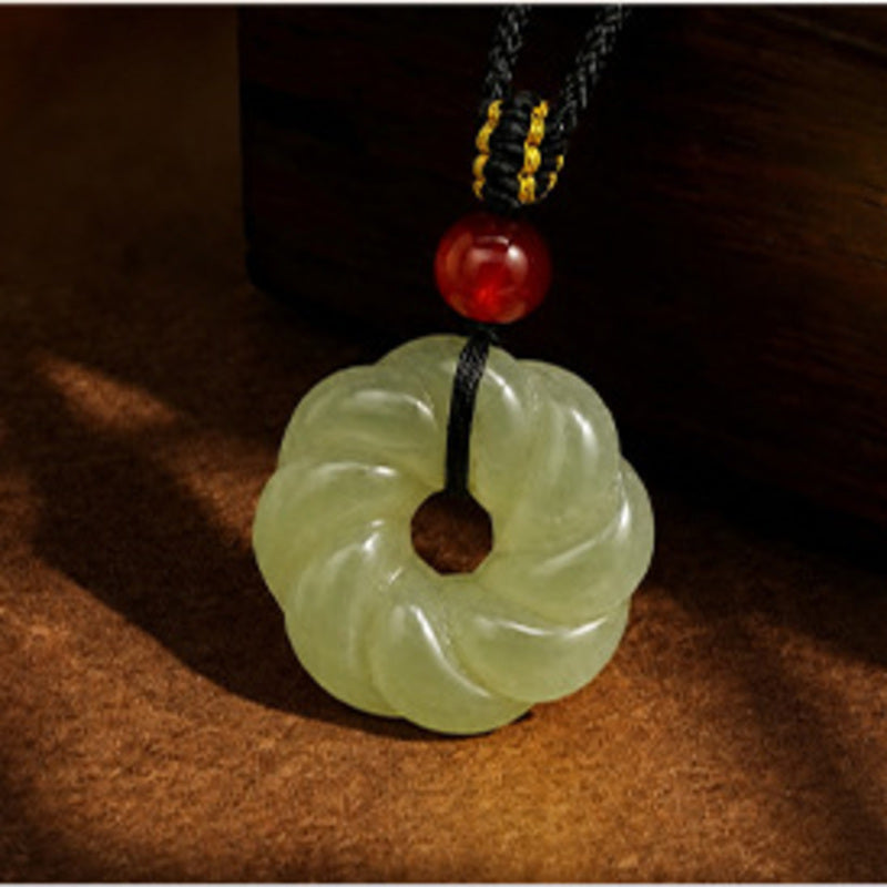 Close view of the nephrite jade twist ring pendant and red agate accent