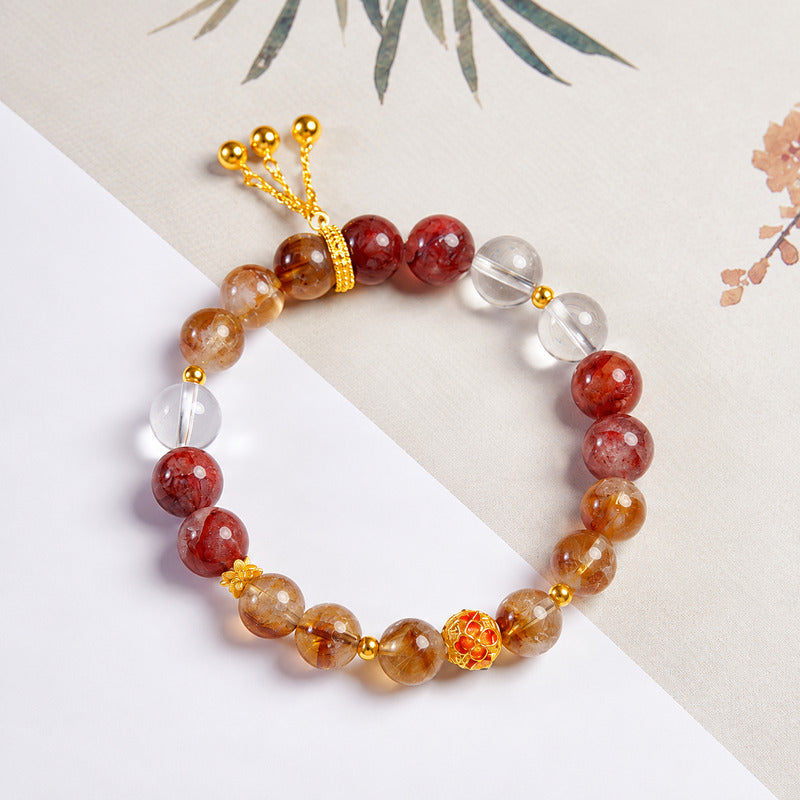 Overhead crystal bracelet view showing enamel flower and delicate tassel