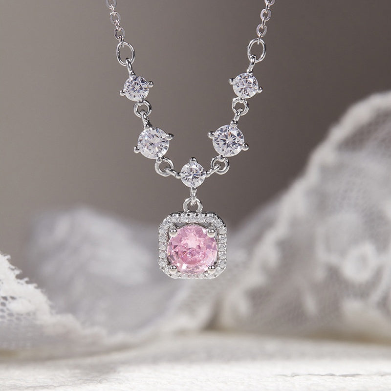 Suspended pink halo necklace showing five clear linking stones