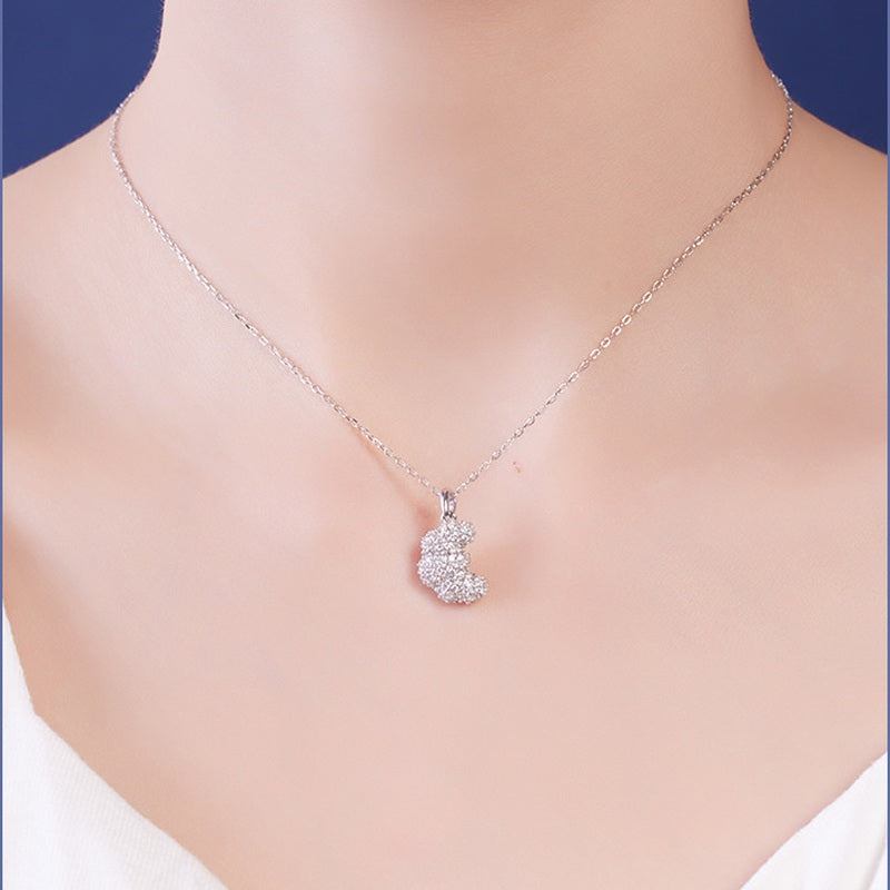 Front view of model wearing silver croissant pendant necklace