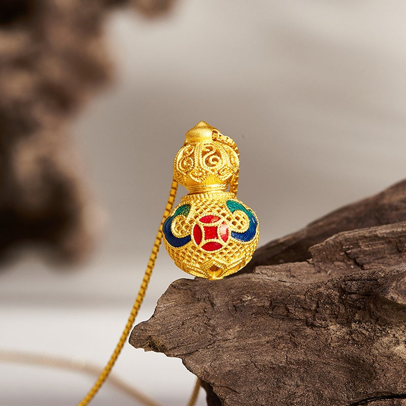 Front view of the coin motif and matte filigree gourd on wood