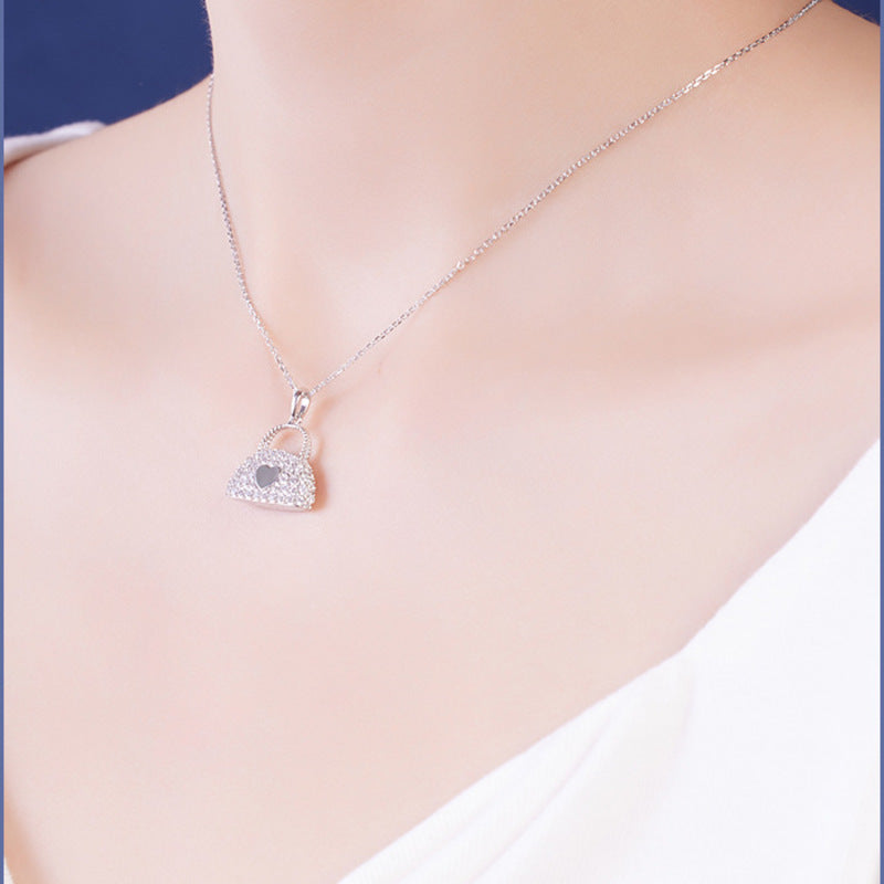 Heart handbag necklace shown from an angled model view