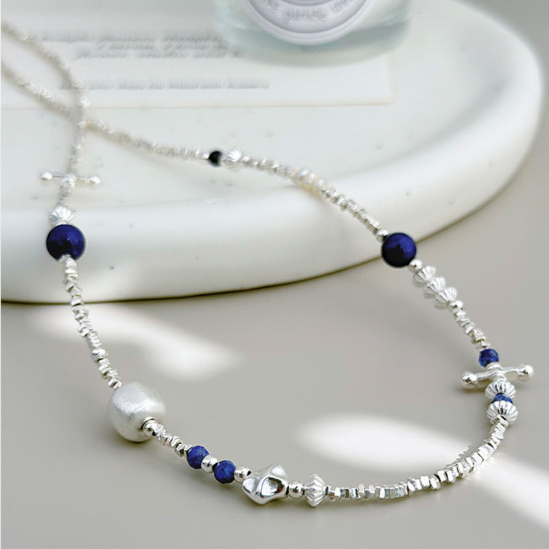 Detailed view of lapis lazuli pearl and textured silver necklace