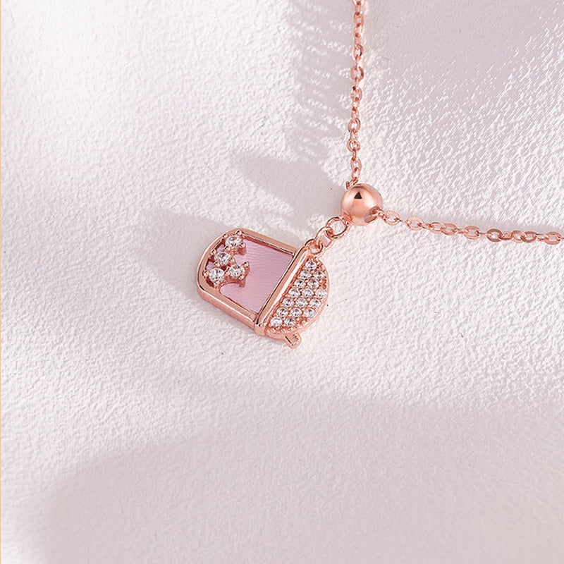 Milk tea cup pendant necklace showing cubic zirconia and pink shell detail