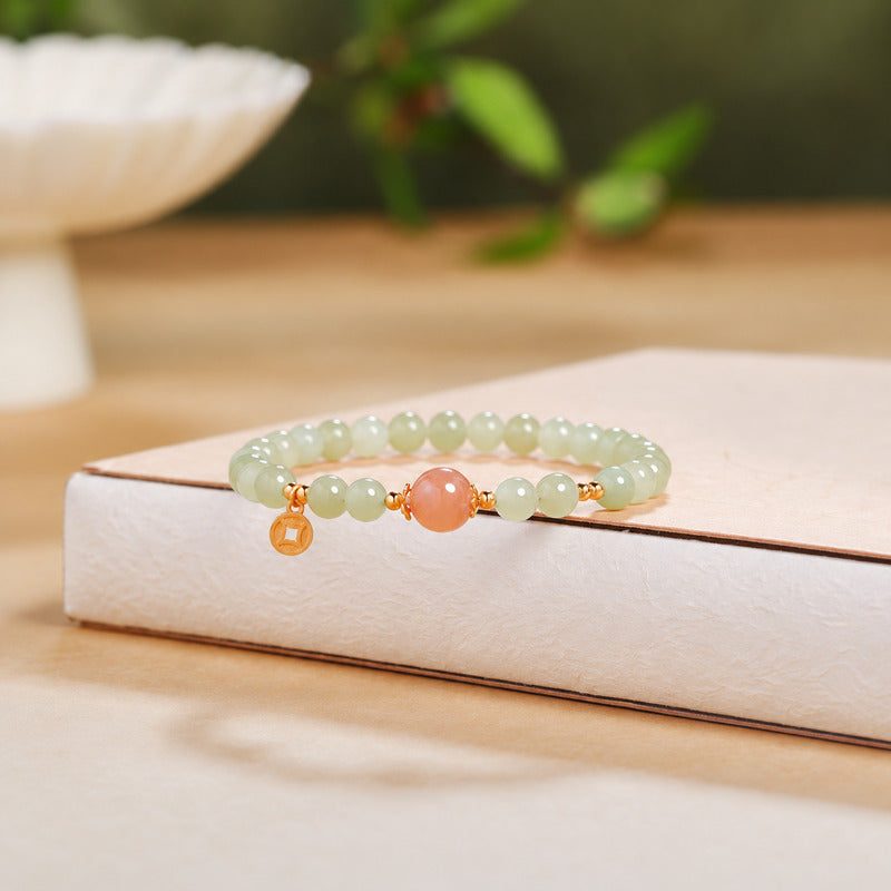 Low front view of nephrite jade bracelet with orange moonstone