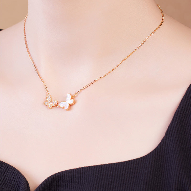 Angled model view of gold-tone double butterfly necklace