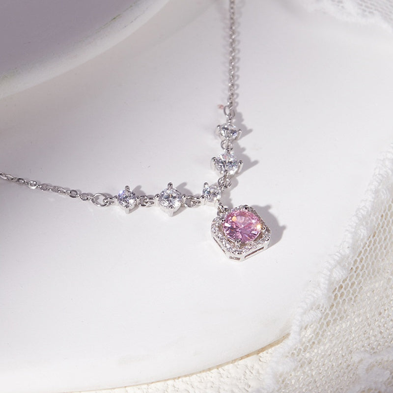 Angled close-up of the pink cubic zirconia halo on pale ceramic