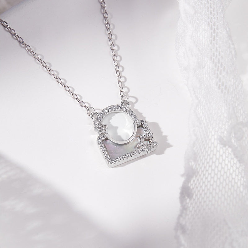 White mother-of-pearl star lock pendant and lace detail