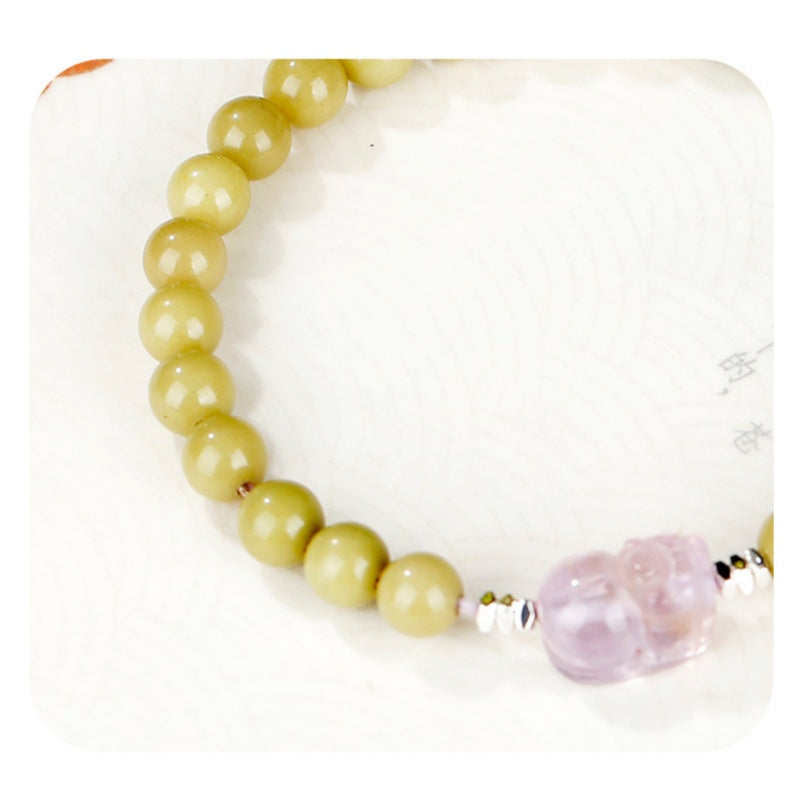 Close detail of amethyst Pixiu carving and green agate beads