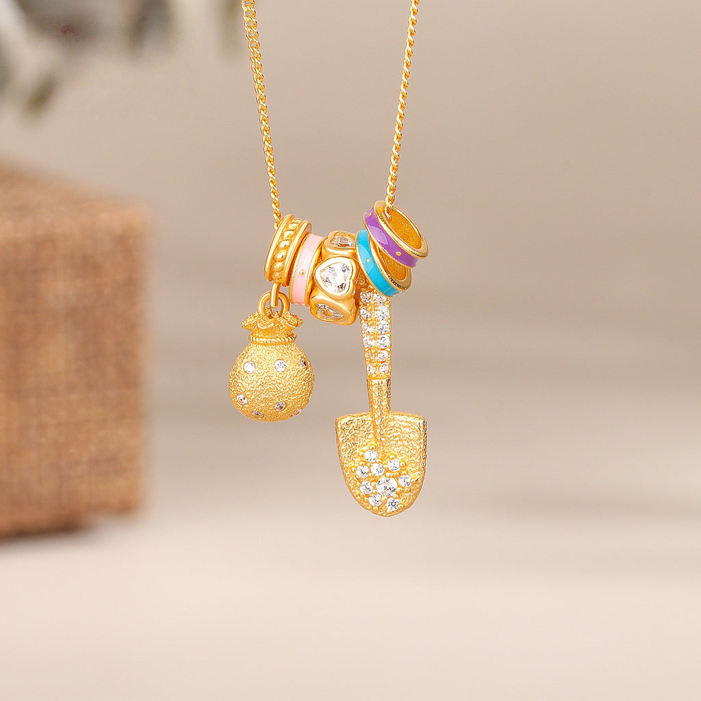 Gold Shovel & Blessing Pouch Necklace – Dig for Joy and Blessings