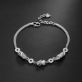 999 fine silver Pixiu and coin bracelet on a dark background