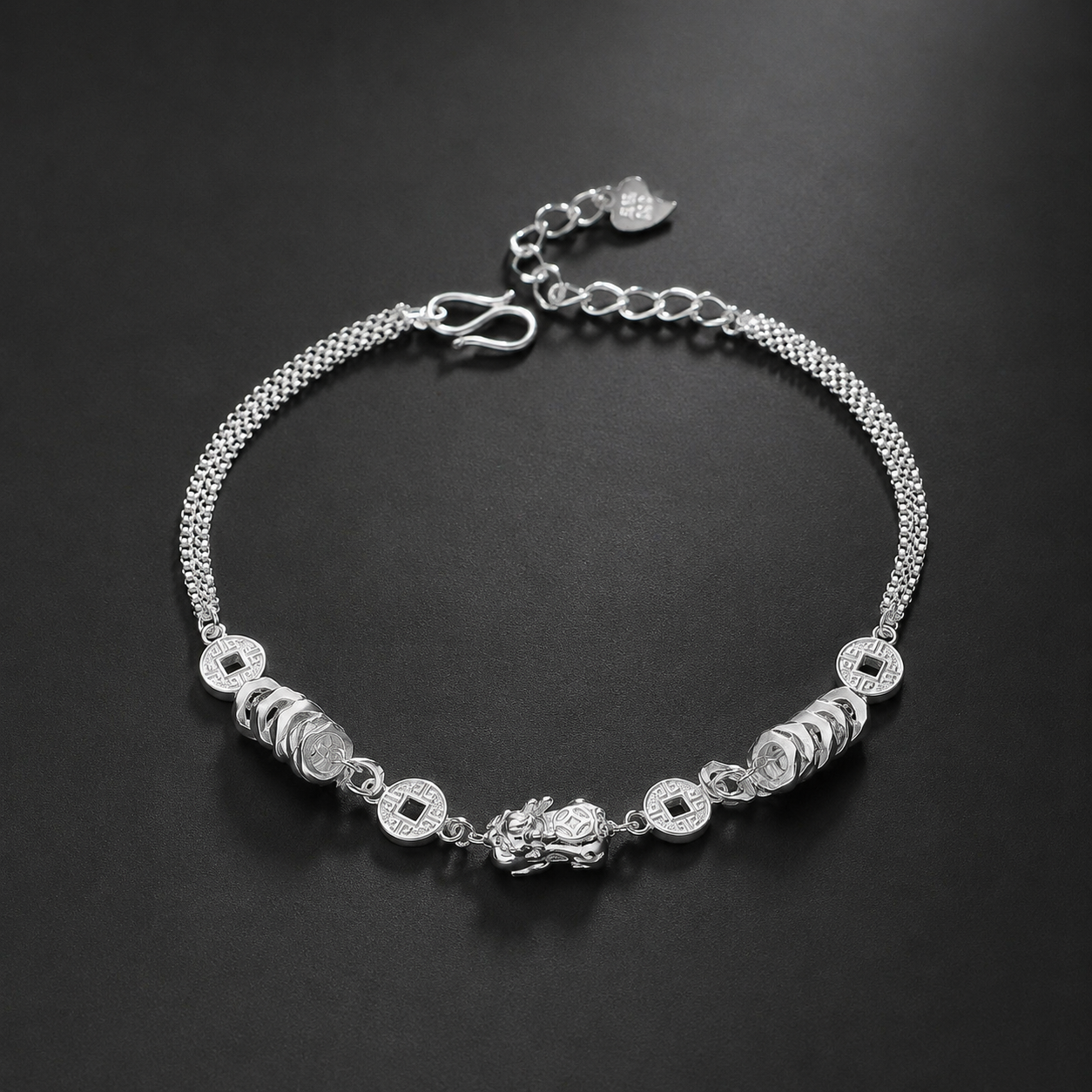 999 fine silver Pixiu and coin bracelet on a dark background