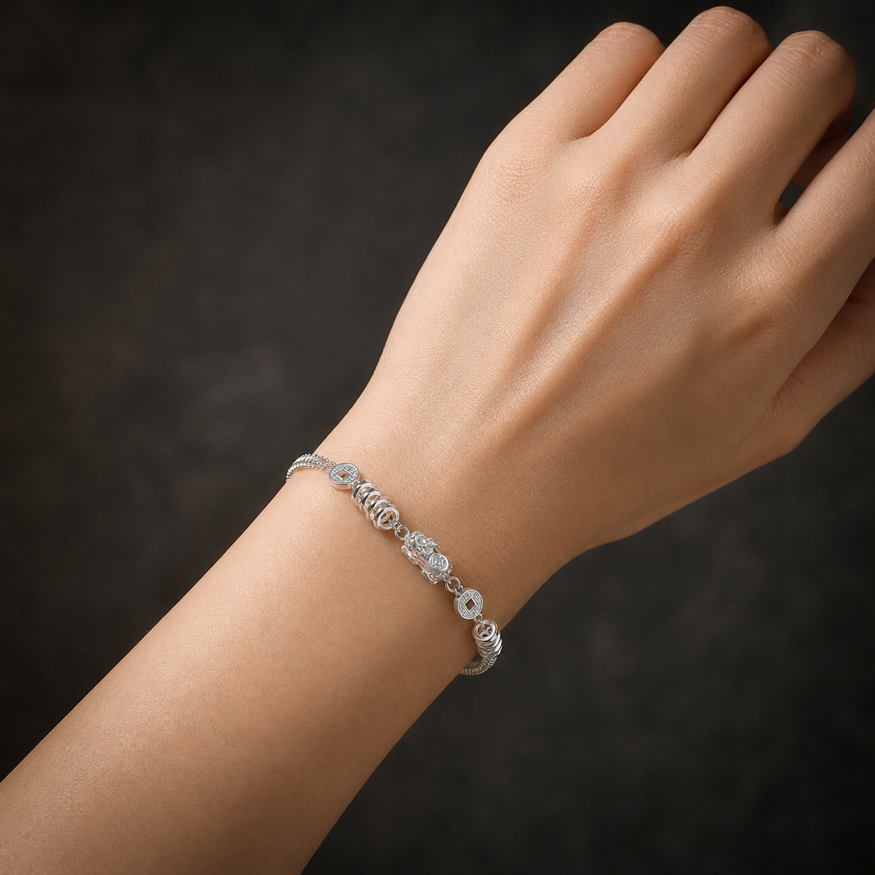 Model wearing a 999 fine silver Pixiu and coin bracelet