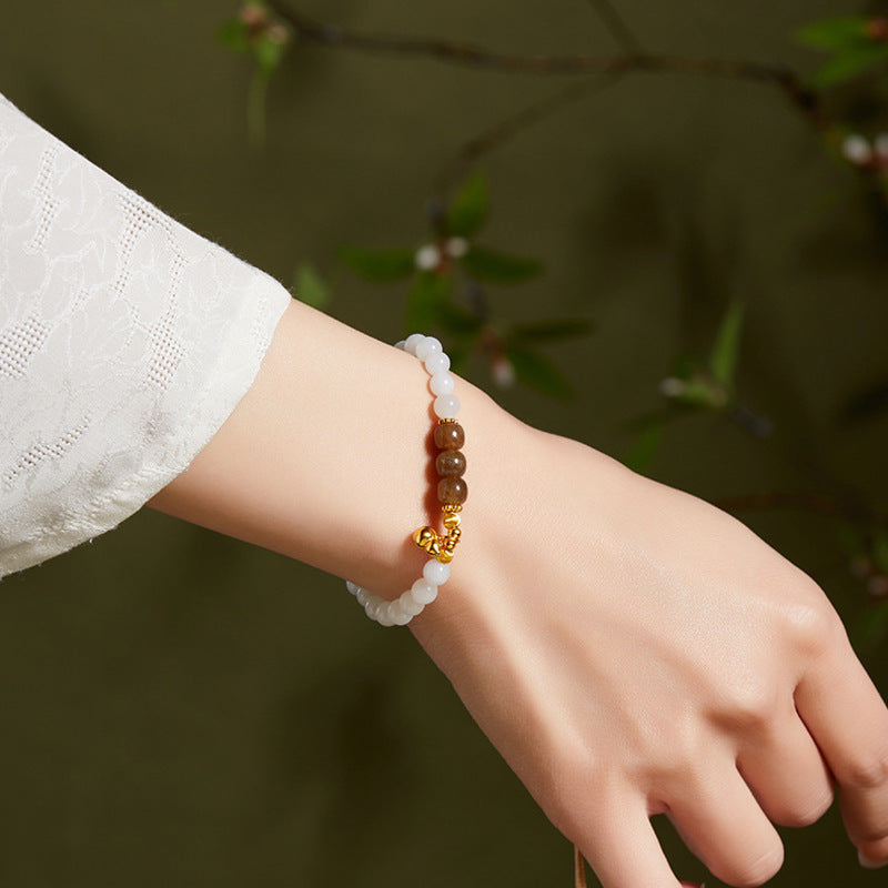 Model wearing white and caramel jade gourd bracelet