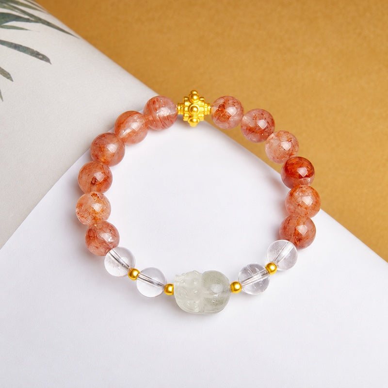 Overhead view of the Pixiu bracelet on an open book
