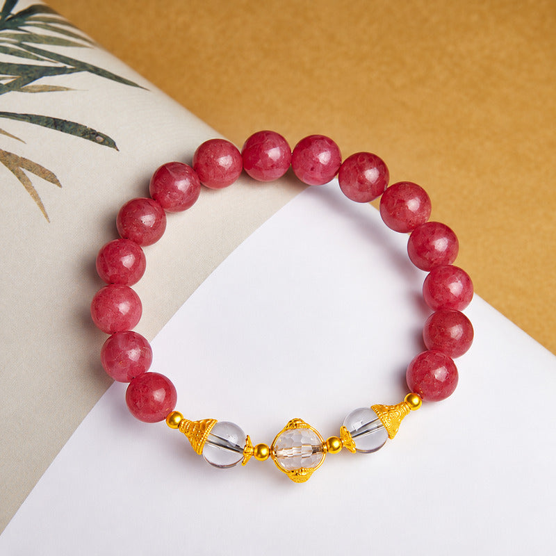 Complete rhodonite bracelet viewed from above on paper