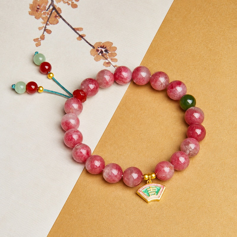 Overhead view of Rhodonite bracelet and its connected beaded cord tails