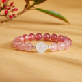 Strawberry crystal and blue moonstone bracelet on a warm botanical background