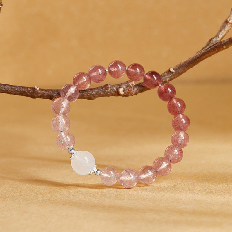 Complete gradient beaded bracelet resting against a branch