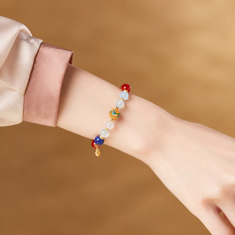 Supplier model wearing the red agate and cold-enamel stretch bracelet