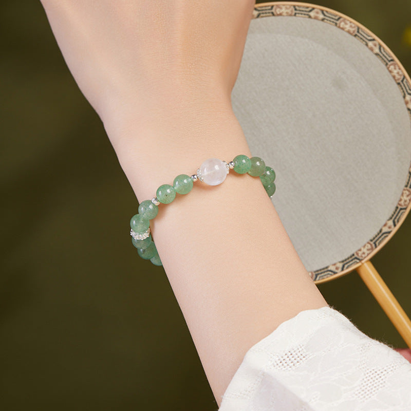 Green moonstone beaded bracelet styled with a white sleeve and round fan